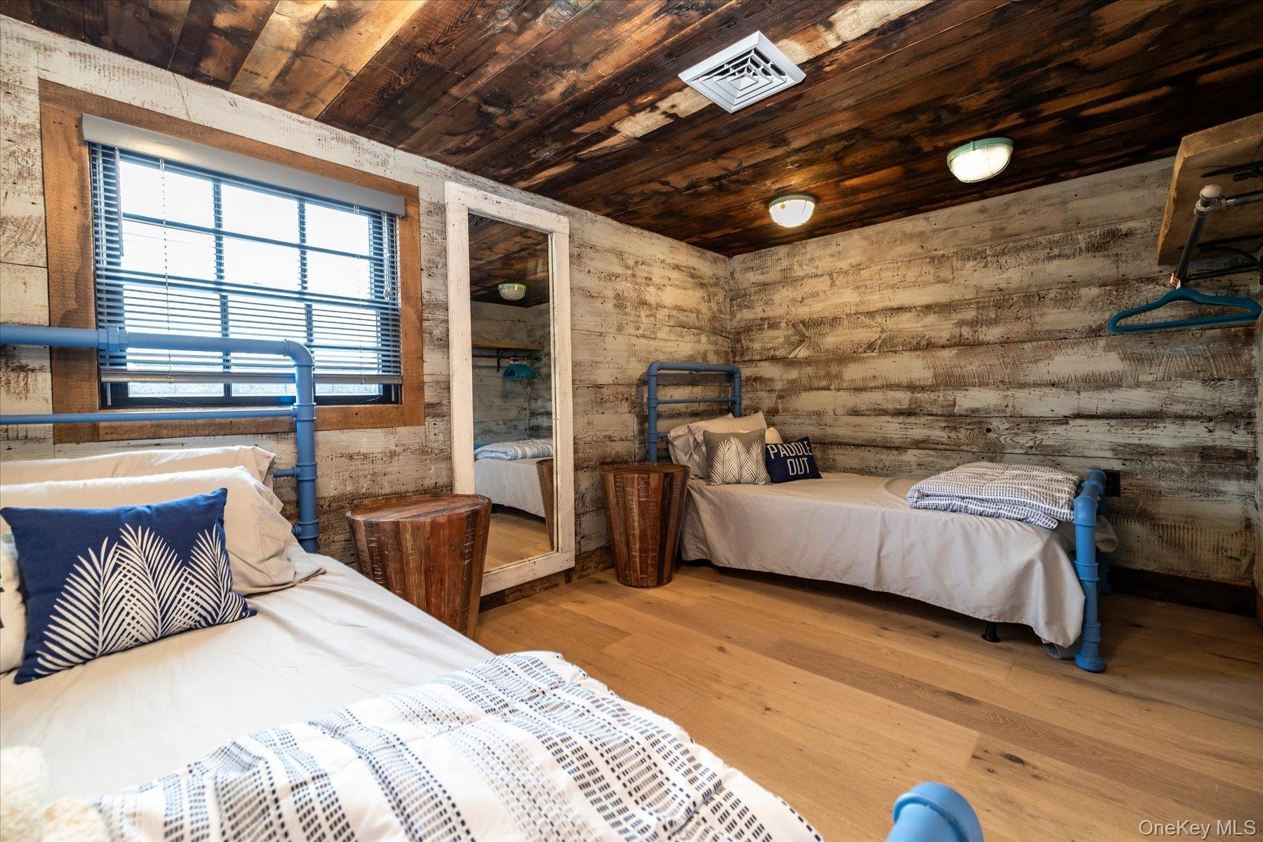 Bedroom with reclaimed wood and flush mount lights