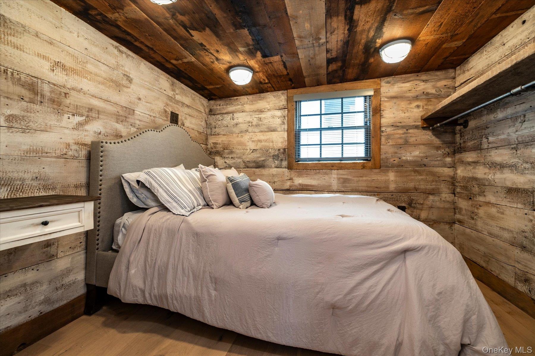 Bedroom with reclaimed wood and flush mount lights