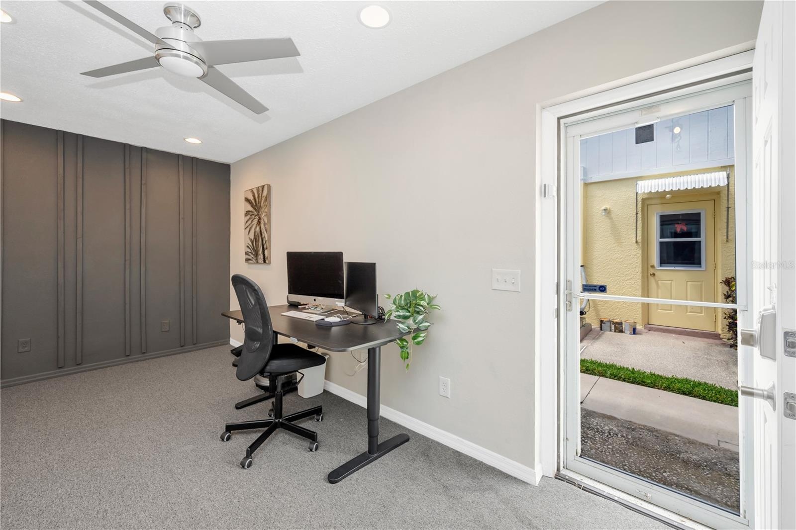 Exterior Door with Storm Door and Sidewalk Access.
