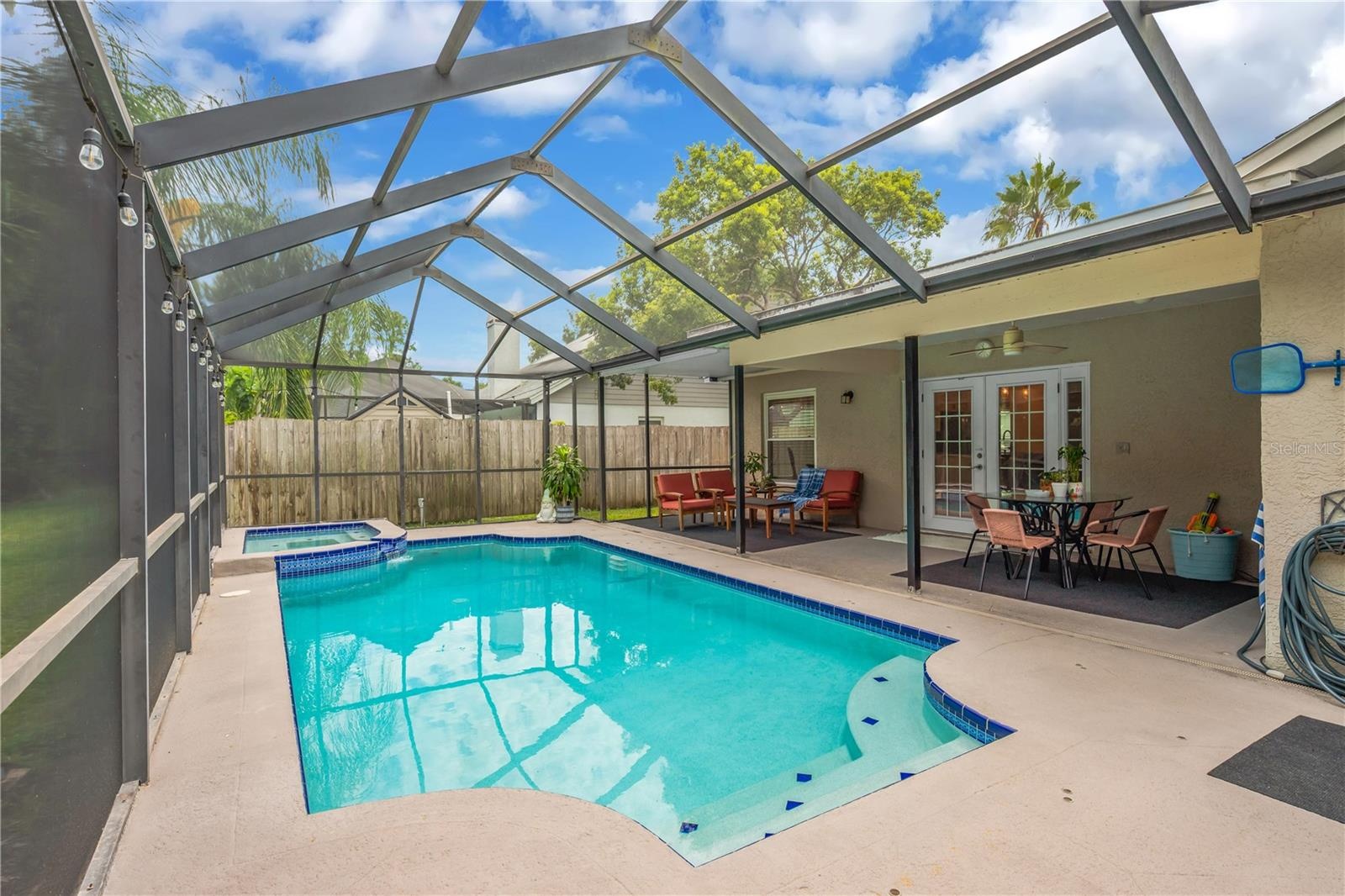 Screened-In Solar Heated Pool with covered seating area