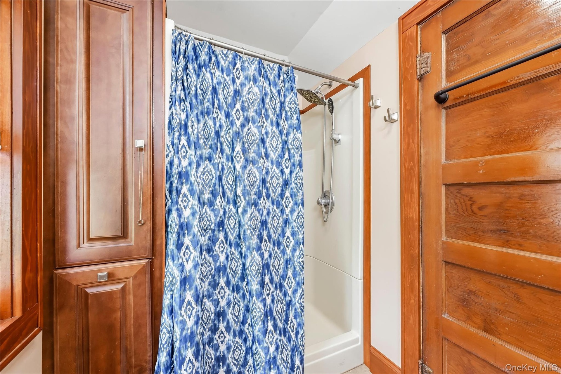 Full bathroom with tub/shower combination and built-in storage.