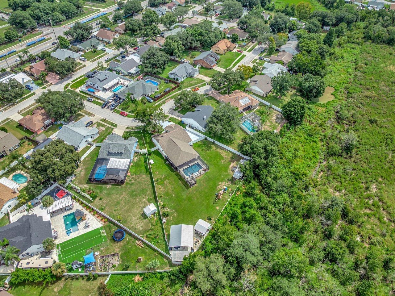 View of Backyard, Playground, Two Covered Open-Air Structured Storage areas with Concrete Pads, Firepit, and Shed. Bring the Boat- Bring the Toys - Th