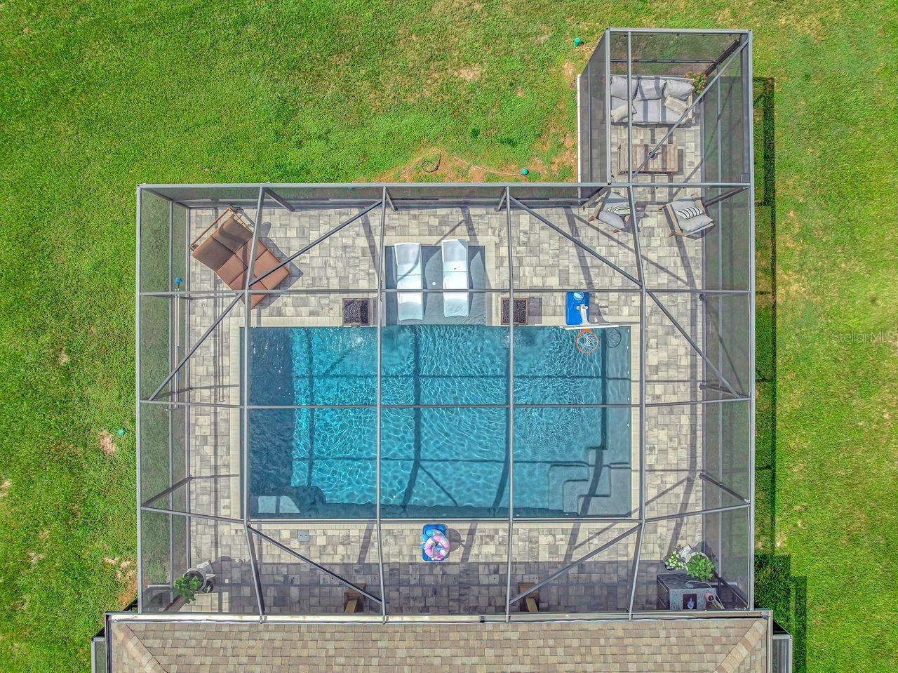 Aerial View of Custom Pool Cage & Pool with additional seating area; pavered deck area; and electric shades.