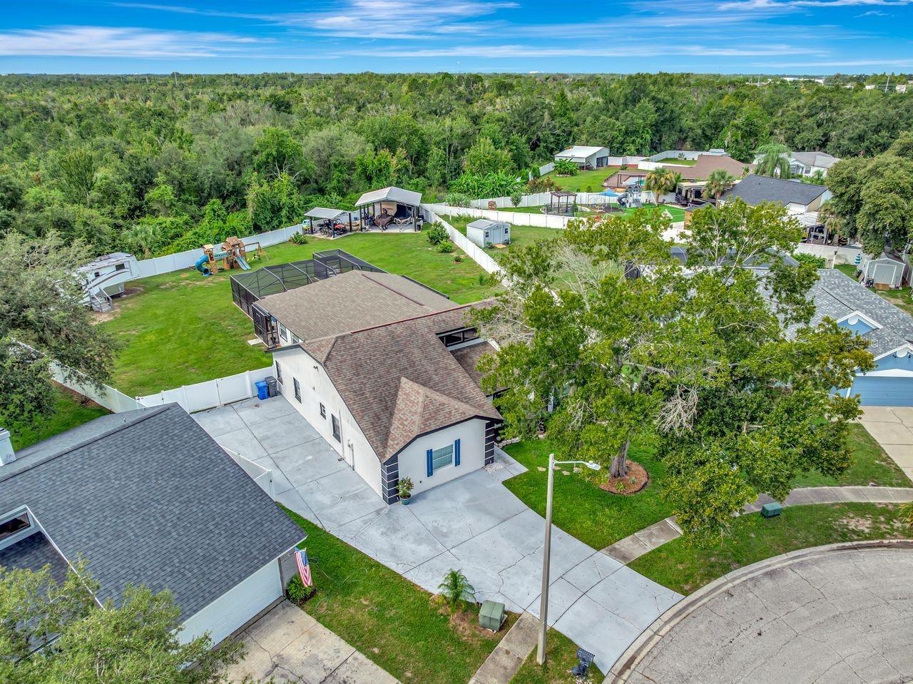 Aerial View of 4 Bedroom Pool Home with extended driveway, side driveway, tons of parking for RV, Boats, Toys, and more!