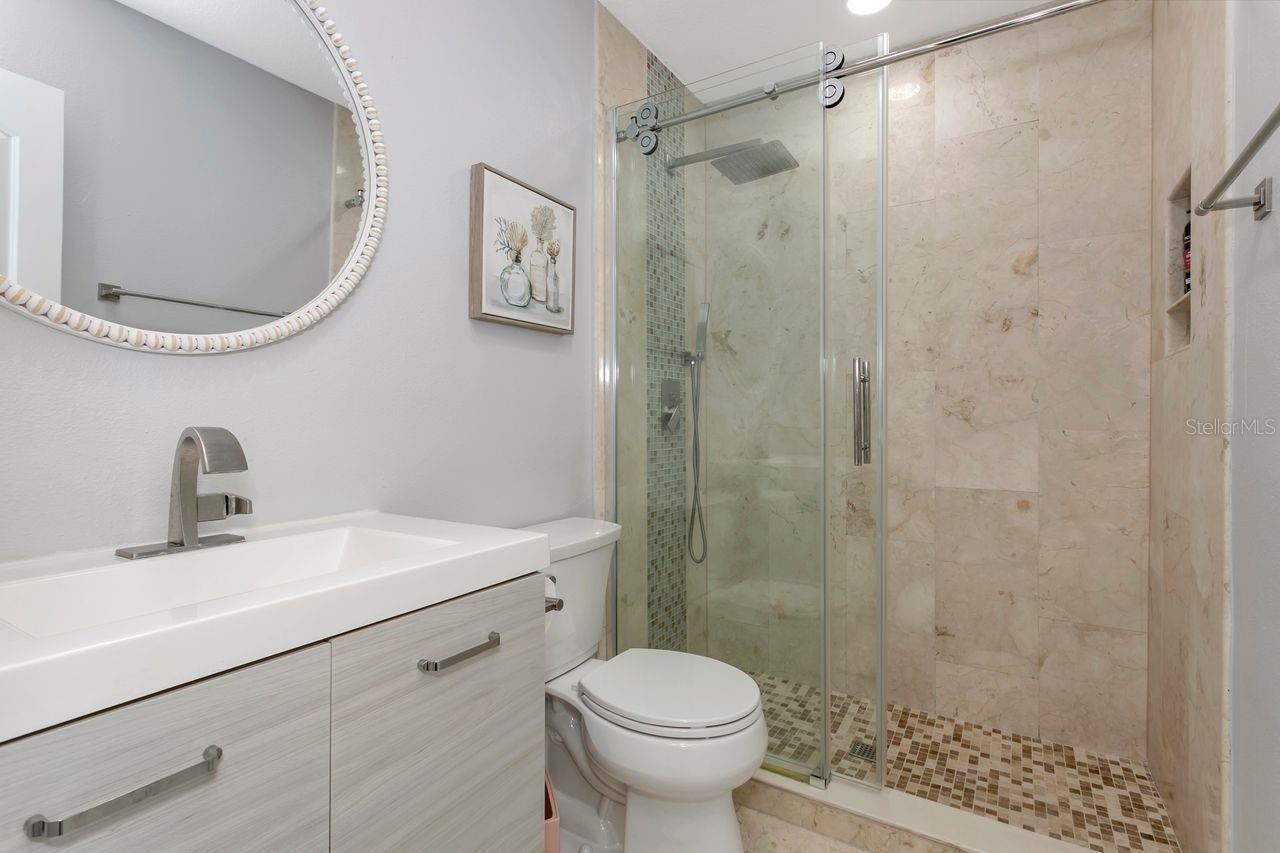 Remodeled Full Bathroom with upgraded fixtures, lighting, Shower with TIle to Ceiling and decorative patterns; upgraded mirror