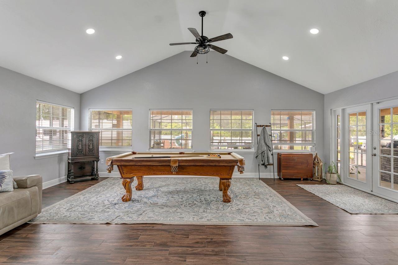 Great Room with Vaulted Ceilings, LVP Flooring, Dual Fans, Recessed Lighting; Tons of Windows, Natural Light, French Doors to your Patio & Covered Lan