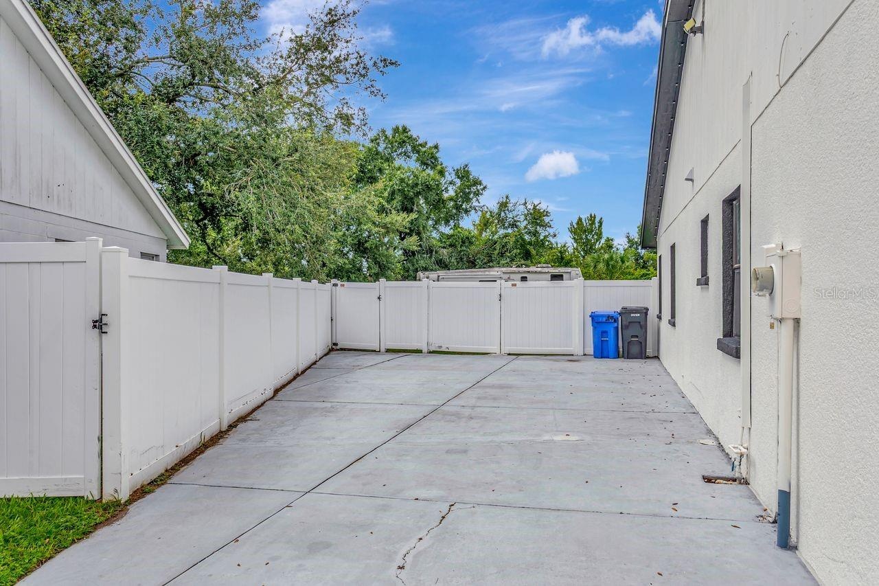 Driveway and expanded driveway area, Home fully fenced, and Double Gates for parking all your toys!