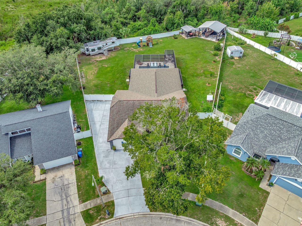 View of Backyard, Playground, Two Covered Open-Air Structured Storage areas with Concrete Pads, Firepit, and Shed. Bring the Boat- Bring the Toys - Th