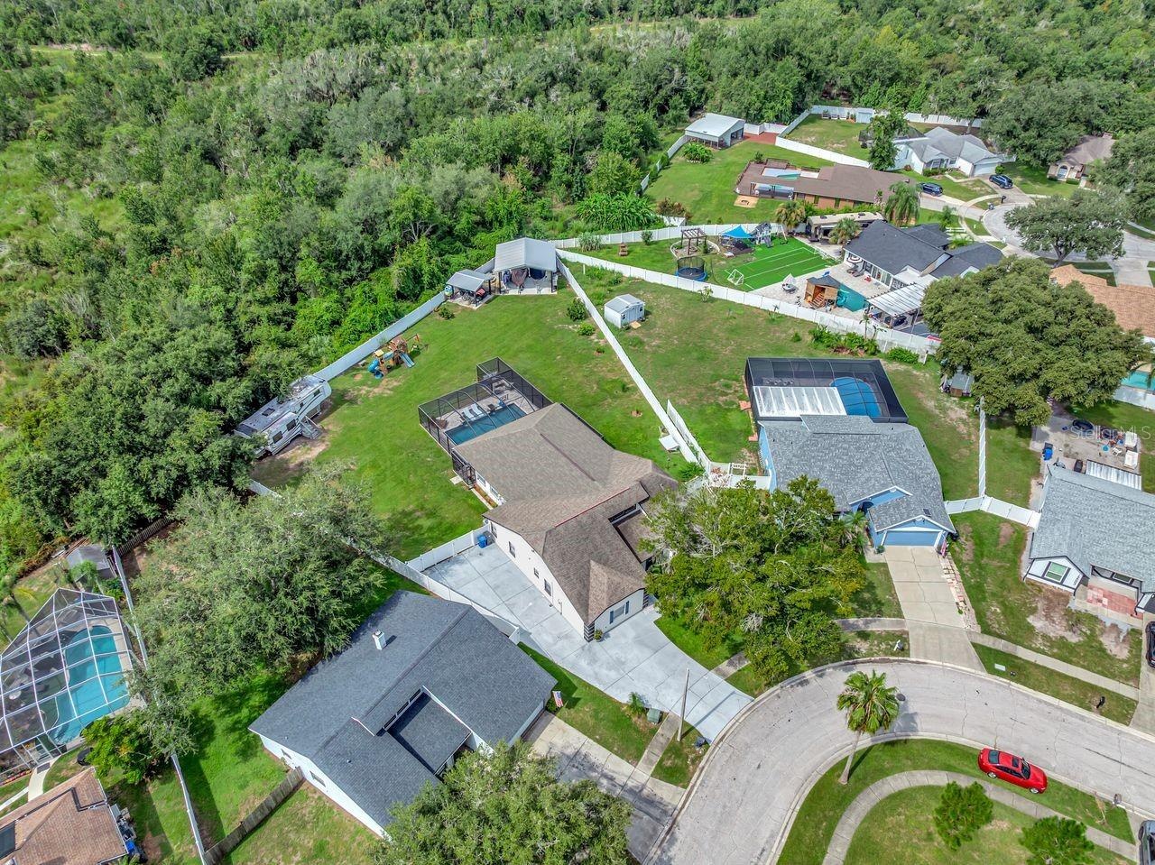 View of Backyard, Playground, Two Covered Open-Air Structured Storage areas with Concrete Pads, Firepit, and Shed. Bring the Boat- Bring the Toys - Th