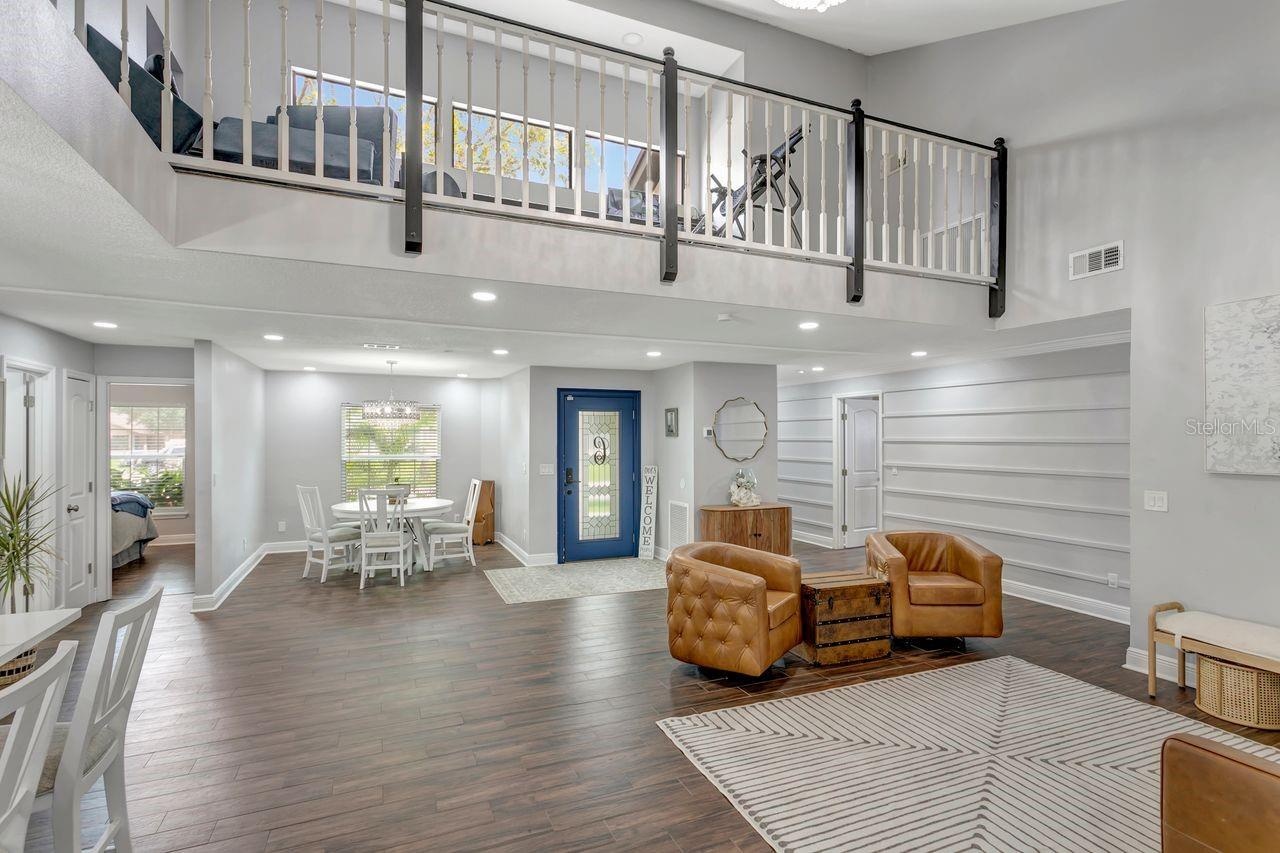 View of Living/Entertainment area; Flex/Dining Space; Unique Alcove; and Entry to Bedroom #4