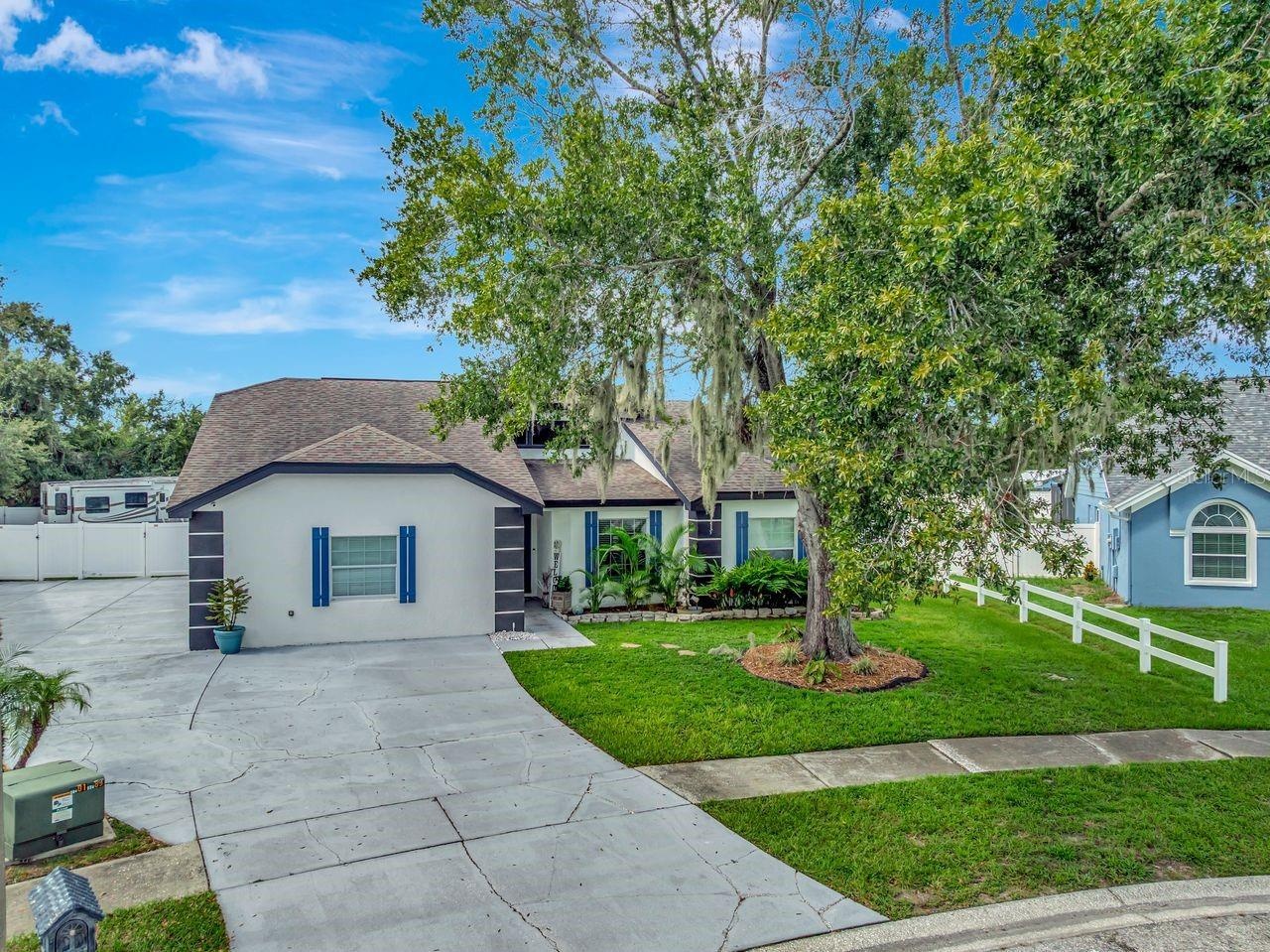 Aerial View of Home; Expanded Driveway; Sidewalks; Mature Landscaping; Double Gates; and More!