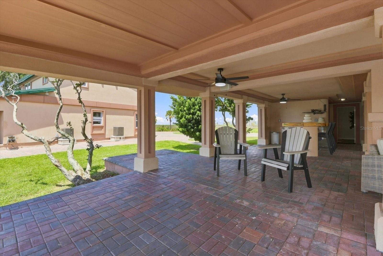 Covered patio extending across the ground level of the residence.