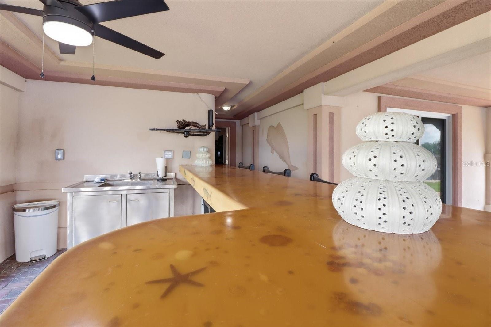 Custom bar top with distinctive coastal-themed detailing.