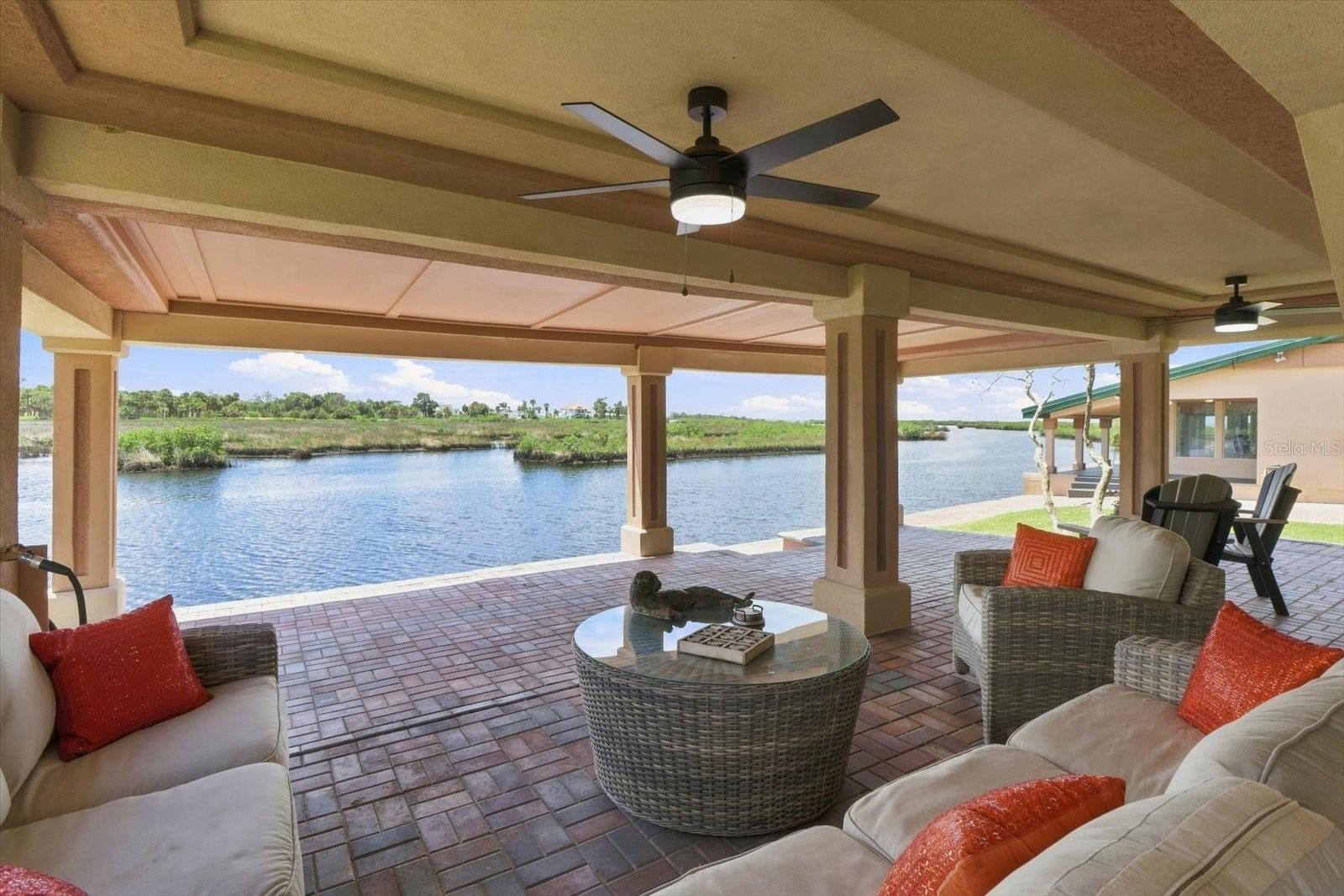Outdoor living area positioned directly along the waterfront.