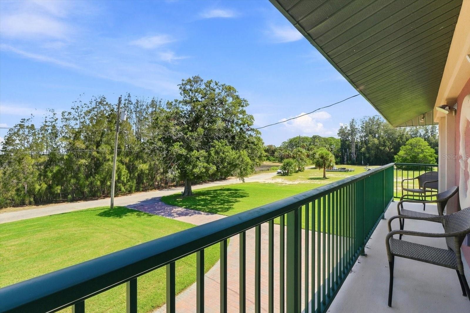 Balcony View – Grounds, Waterfront & Neighboring Residence