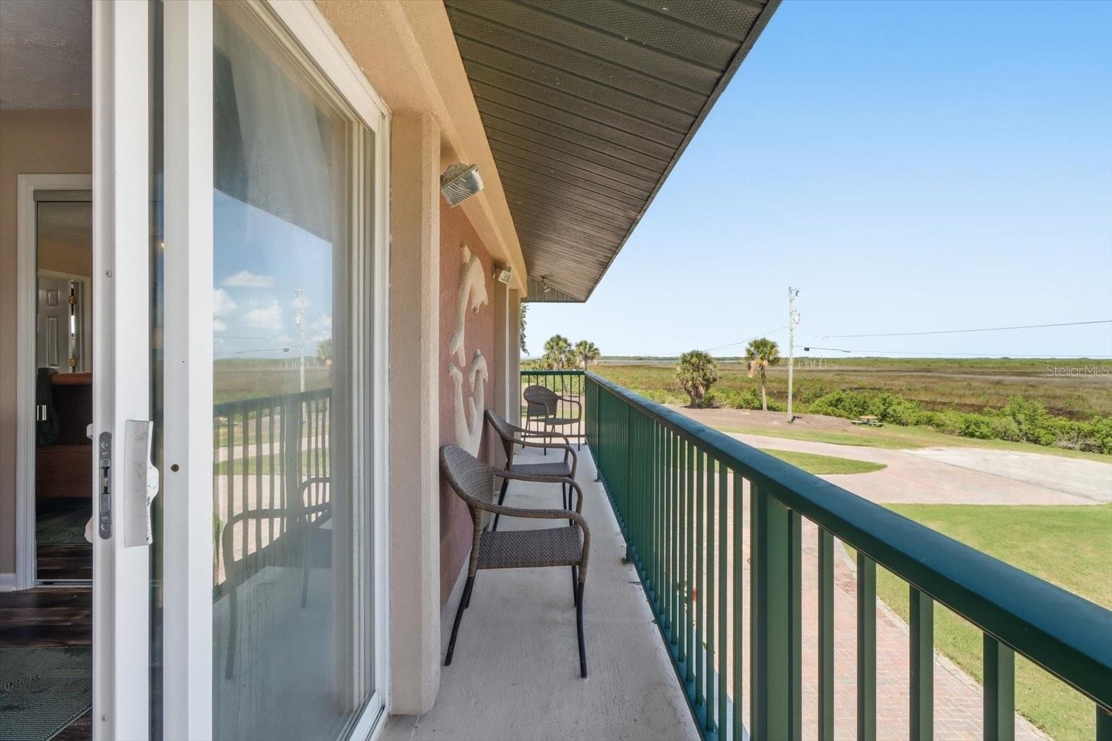 Covered balcony extending along the side of the residence.