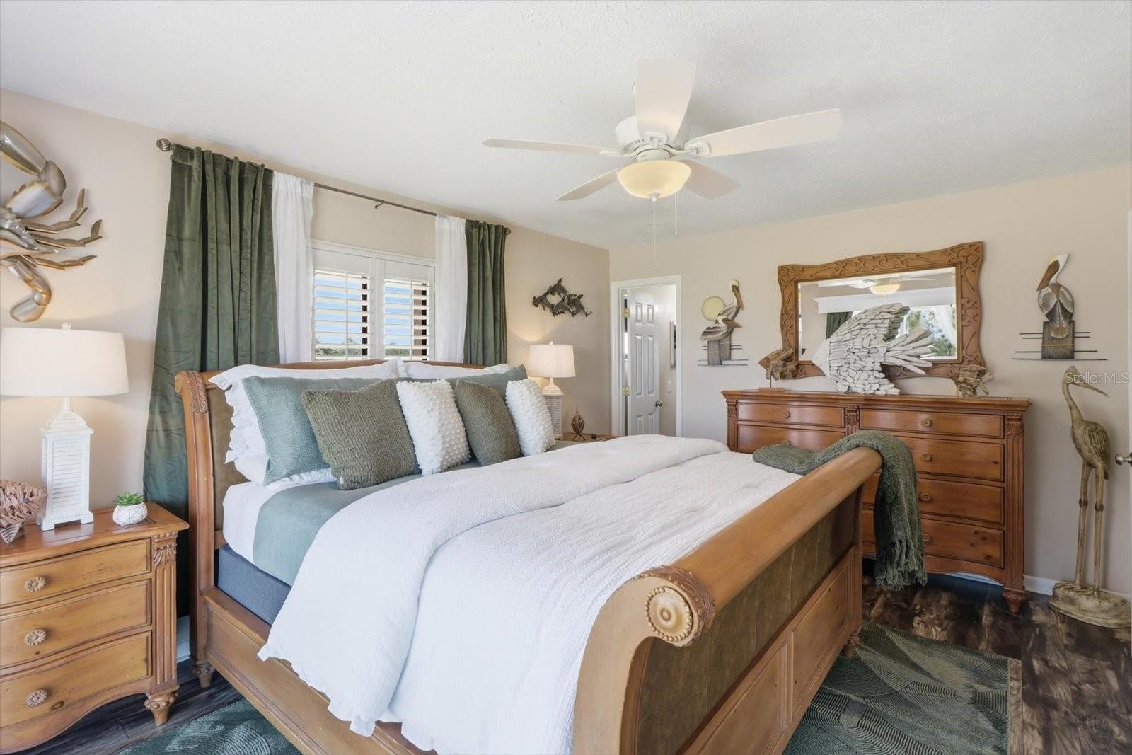 Primary bedroom with coordinated coastal furnishings.