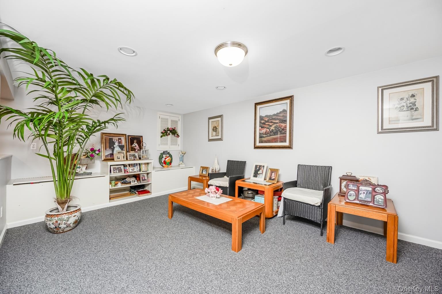 Recessed lighting, flush mount ceiling fixture, built-in cabinetry, built-in shelving, and carpeted flooring