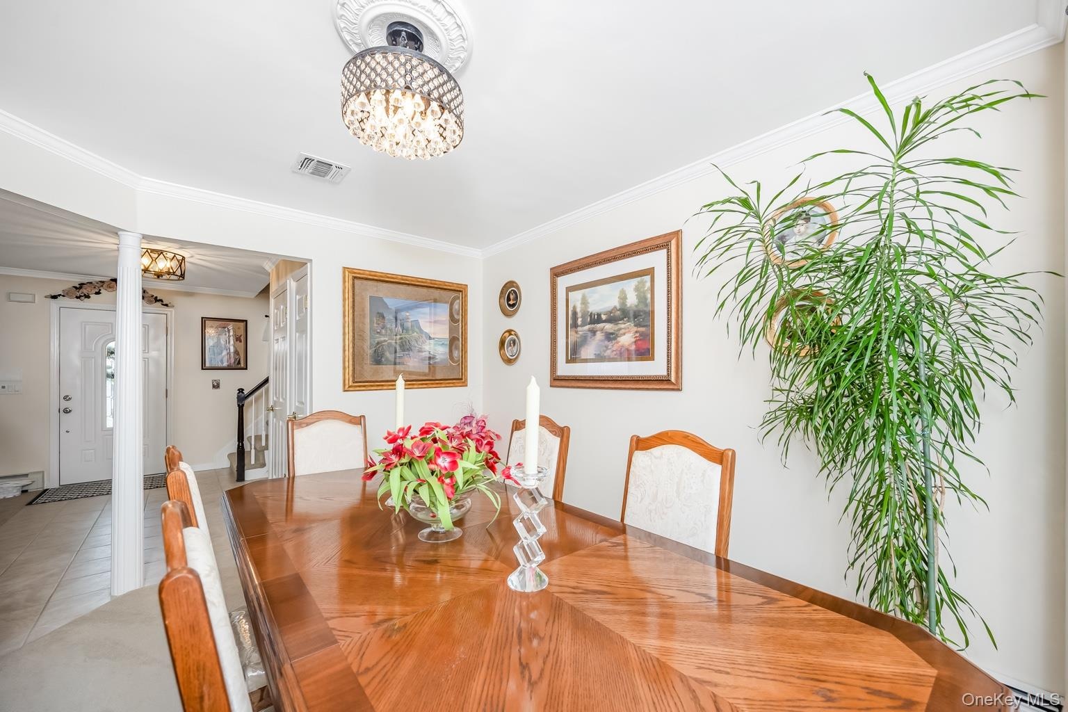 Recessed lighting, crown molding, and a chandelier with a ceiling medallion