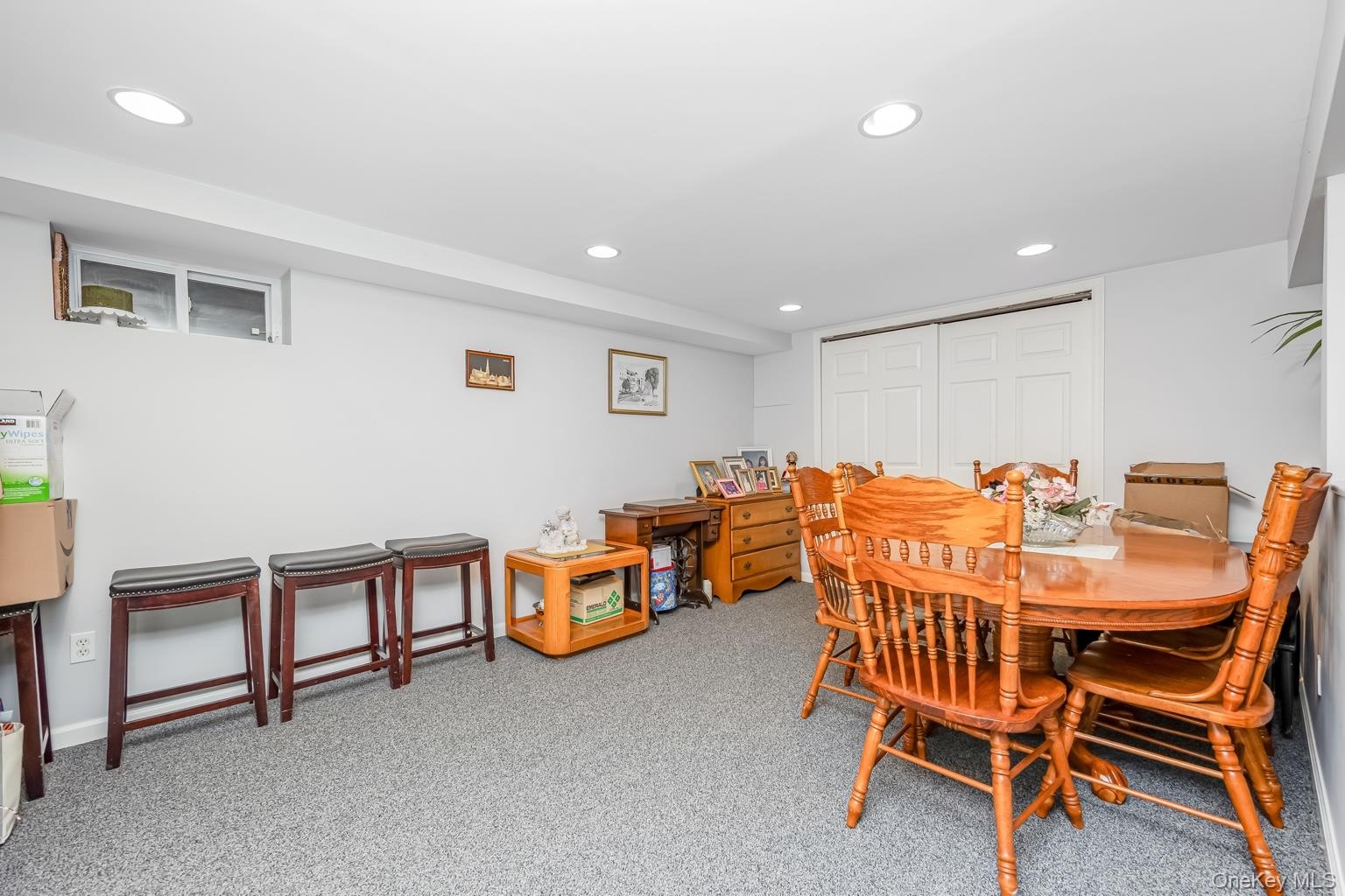 Recessed lighting, light-toned walls, and carpet flooring
