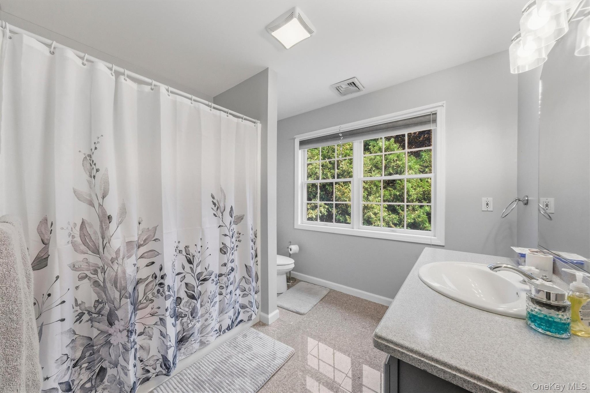 Full hallway bath with a tub and shower.