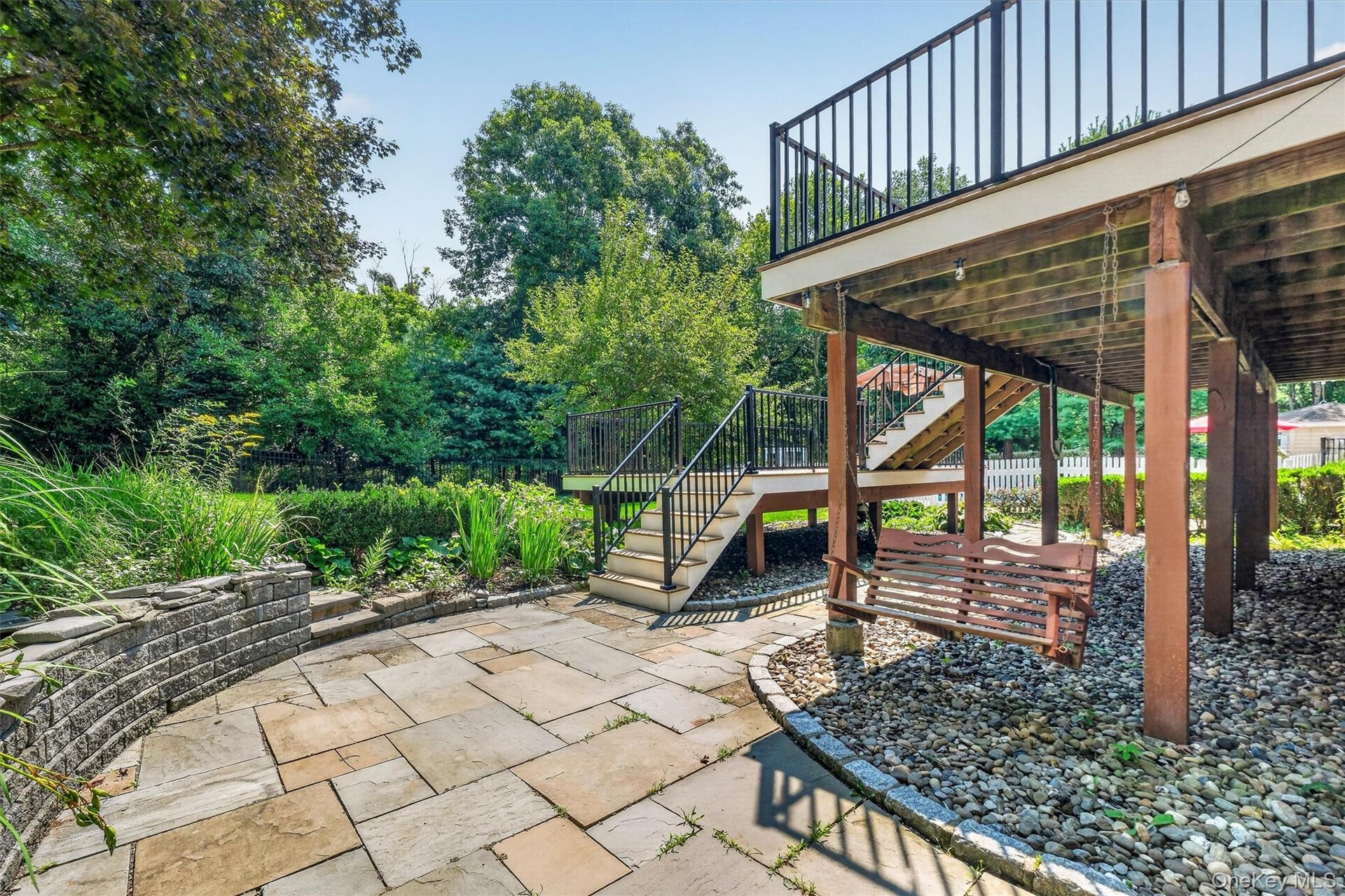 Sliders in the basement provide walk-out access to a beautifully manicured backyard, complete with a double deck and a fenced-in pool area that’s perf