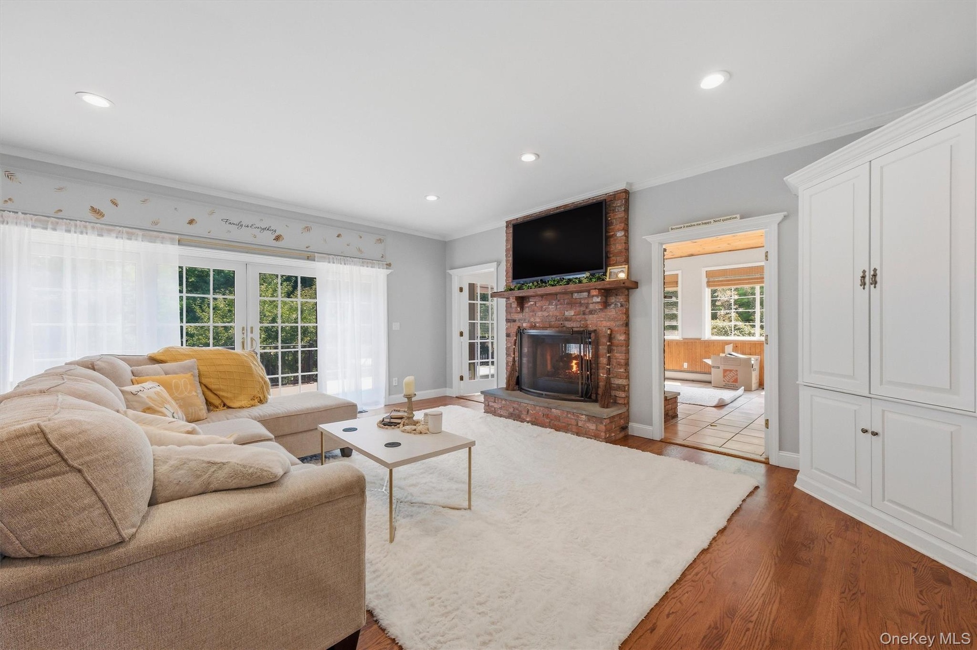 The family room features sliding glass doors that open to a two-tiered deck, as well as convenient access to an all-season sunporch.