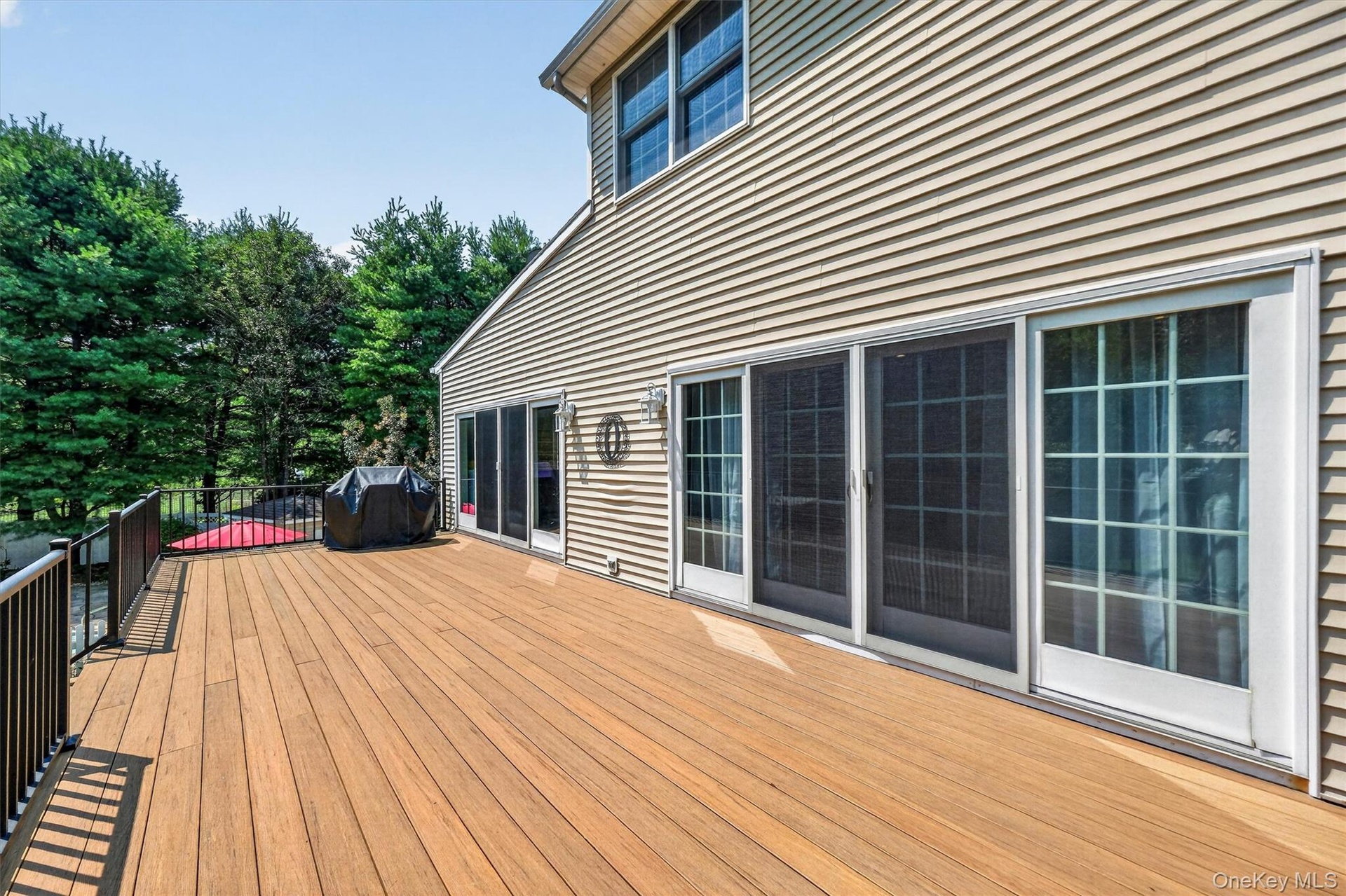 The top-level of the deck can be accessed via sliders from both the family and sun rooms.