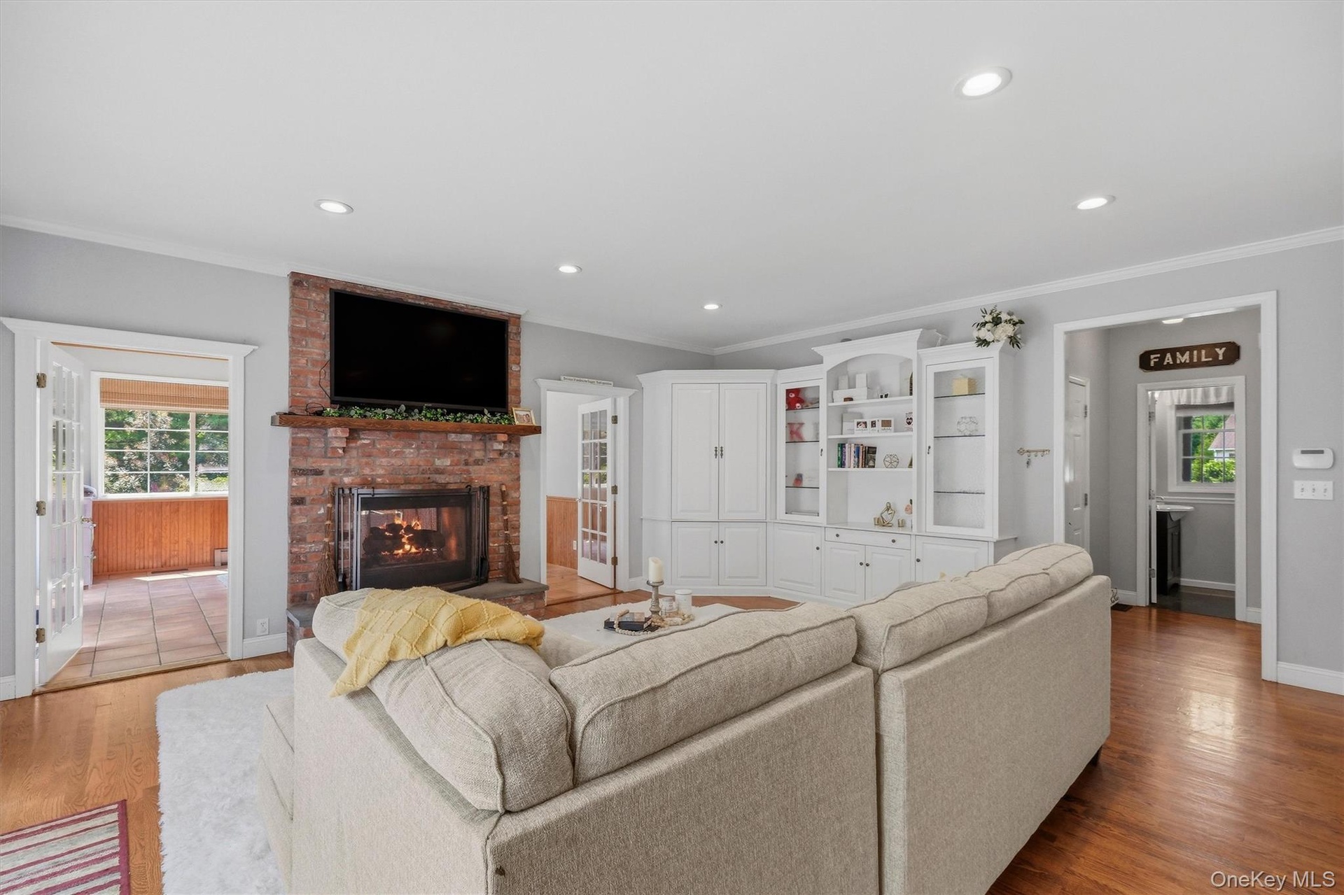 A more casual family room offers a place to watch TV by another (two-sided) gas fireplace.