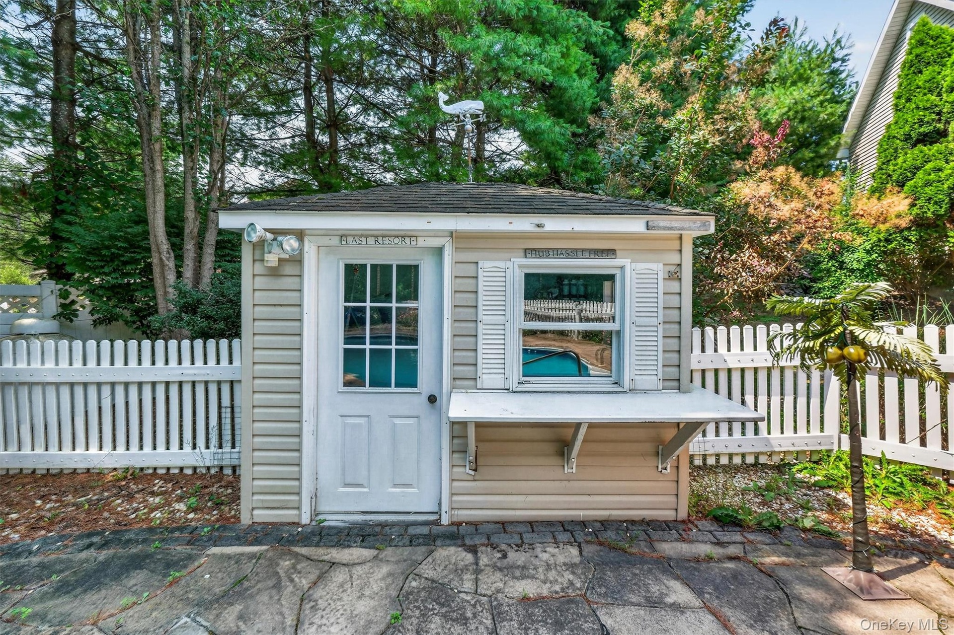 An additional pool shed offers convenient storage for pool equipment, maintenance supplies and floats.