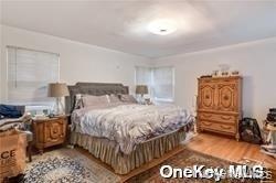 Primary Suite with door to backyard. Hardwood flooring throughout
