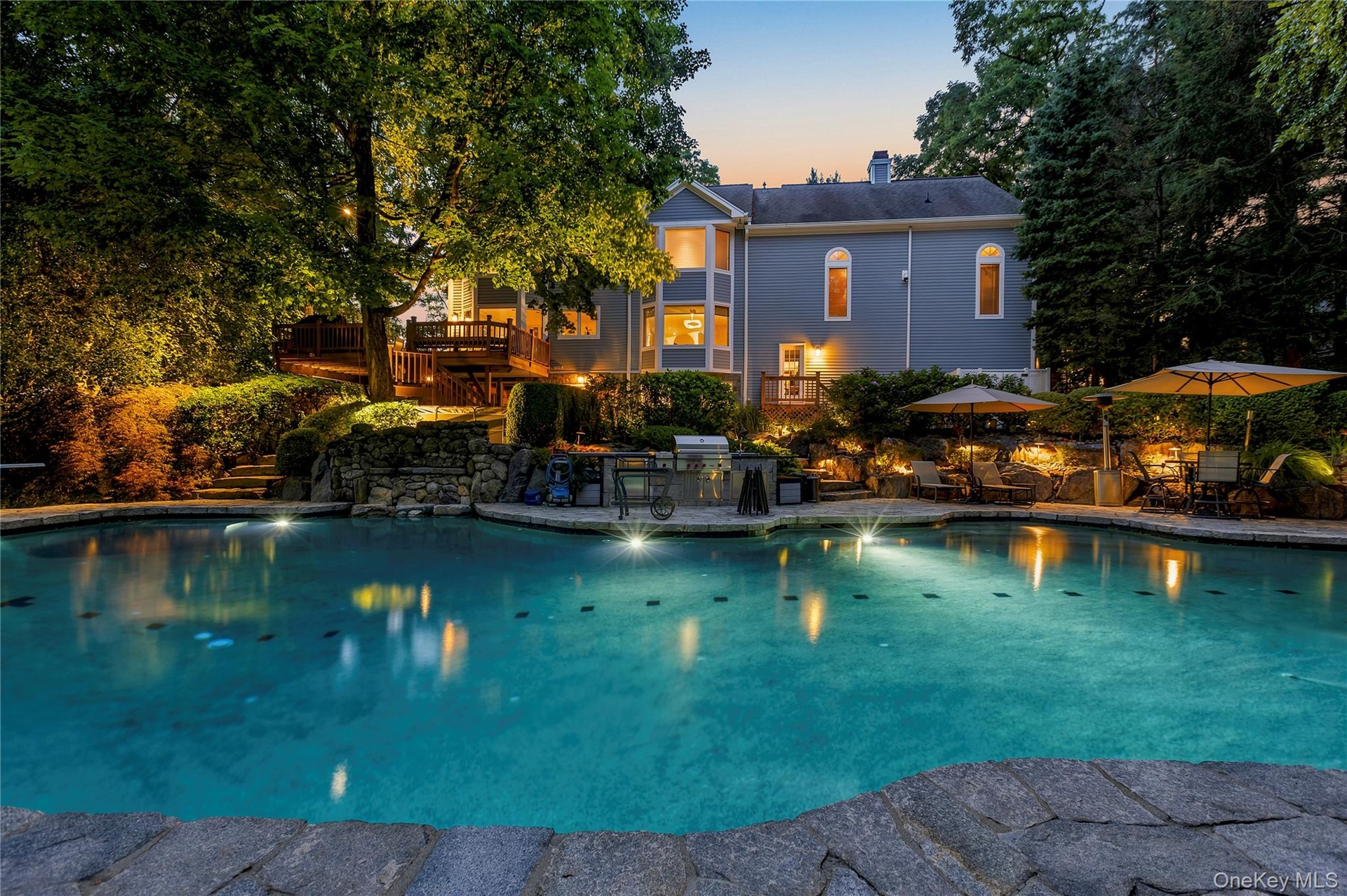 Exterior lighting adds to the beauty of the pool area at night