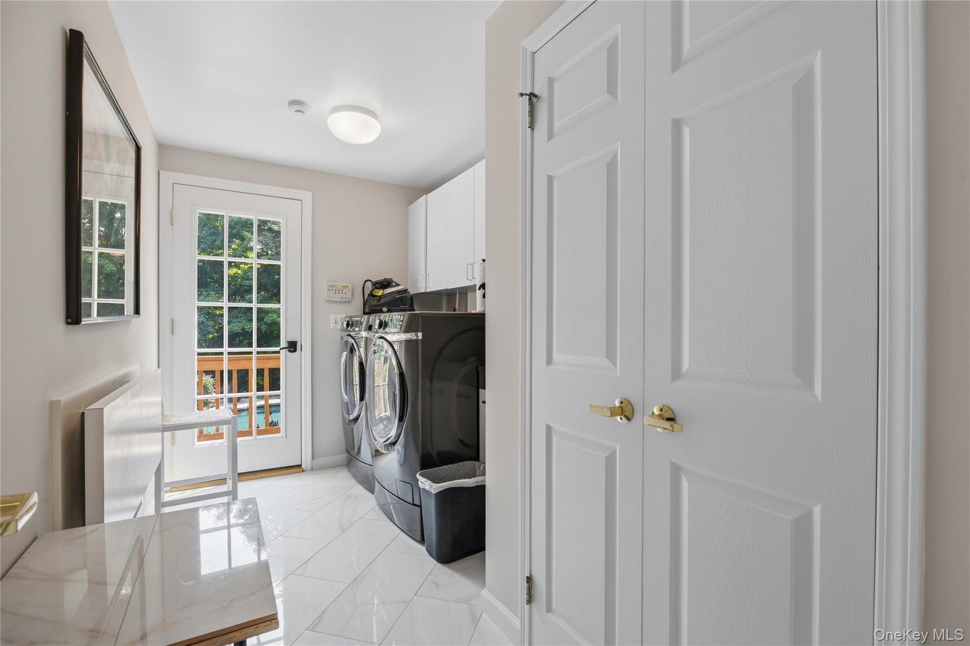 Spacious Laundry room with French Door to yard, double closets and door to 3-car garage