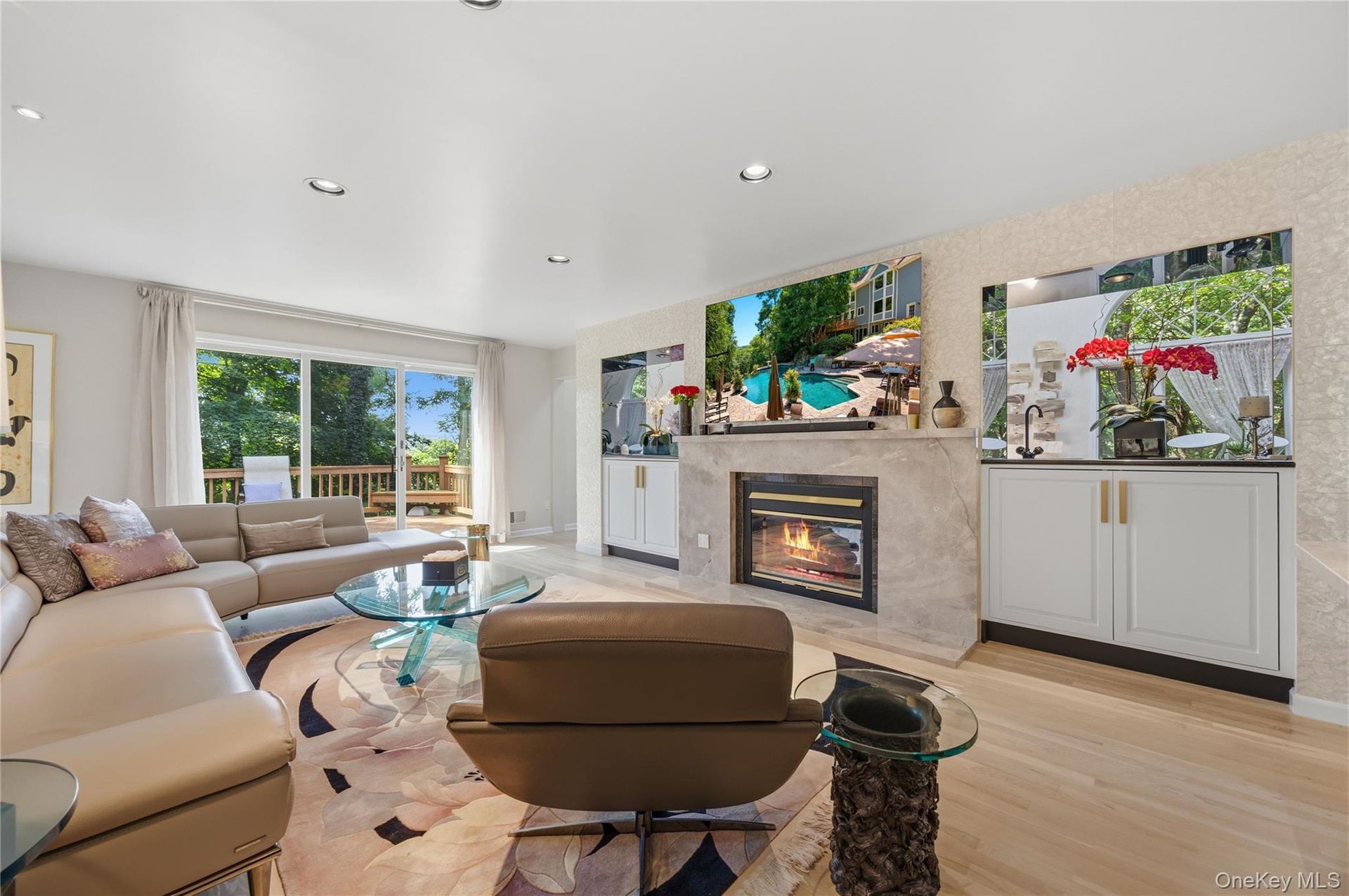 Family Room with sliding glass door to deck, recessed lights, wood burning Fireplace with marble surround, Wet Bar & B/I cabinets, Mother of Pearl acc