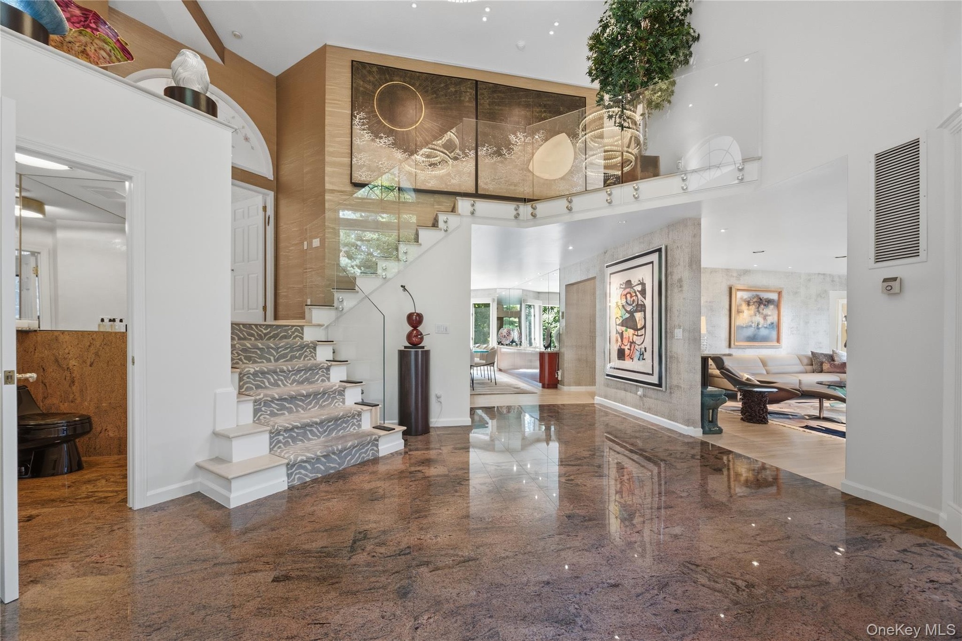 Back down through dramatic entrance foyer to Lower Level