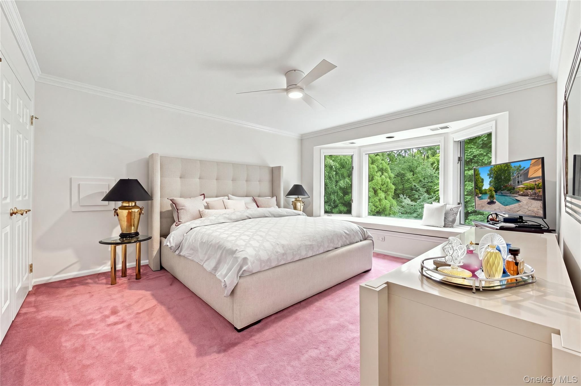 Fourth Bedroom with ceiling fan, laundry chute, two double wide closets, bay window with seat