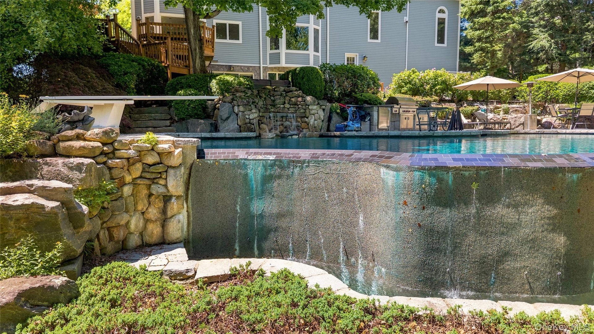 Infinity Edge of the free form pool with stone outcroppings