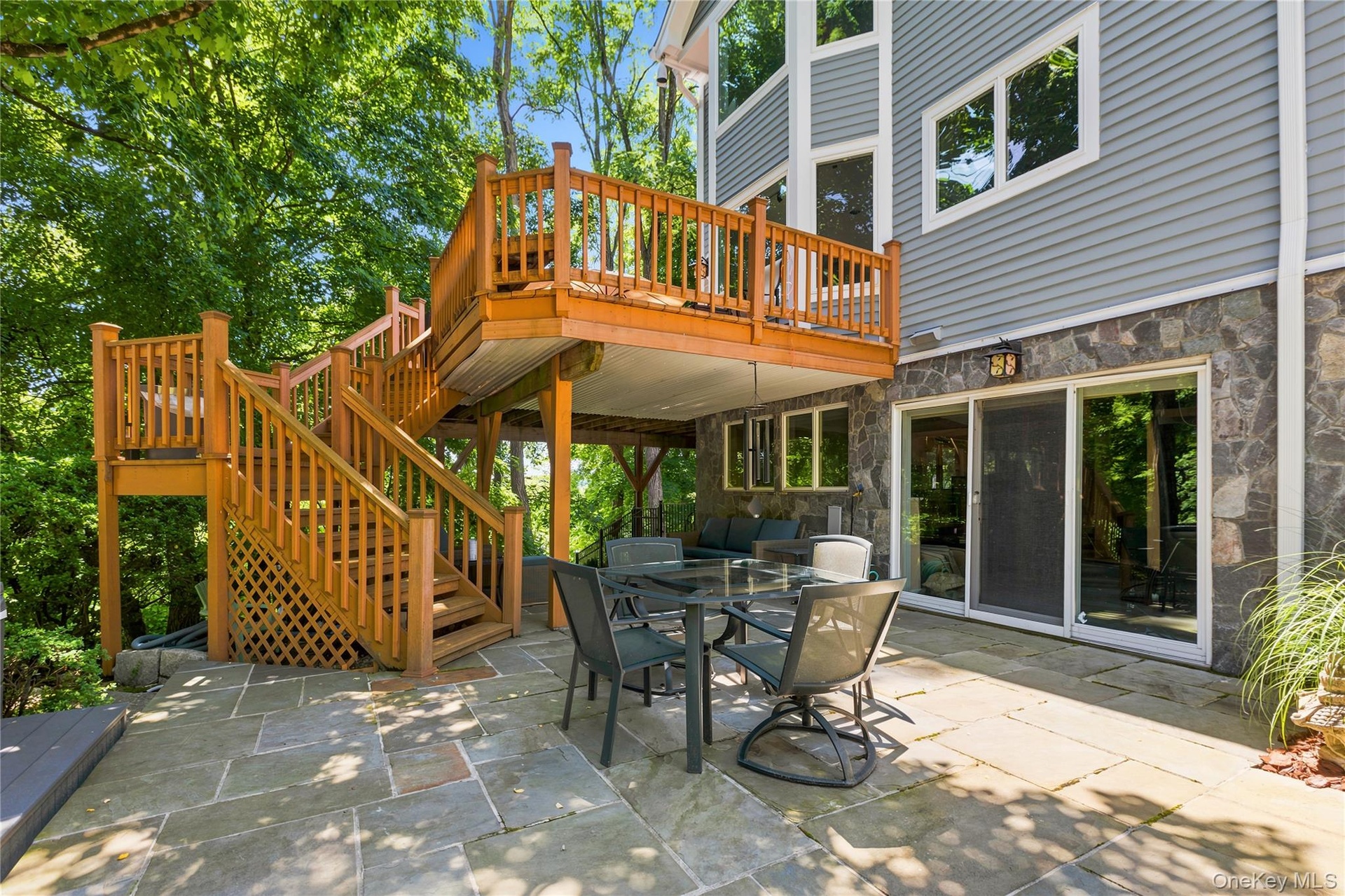 Rear Patio off of walk-out Lower Level with steps to upper Deck