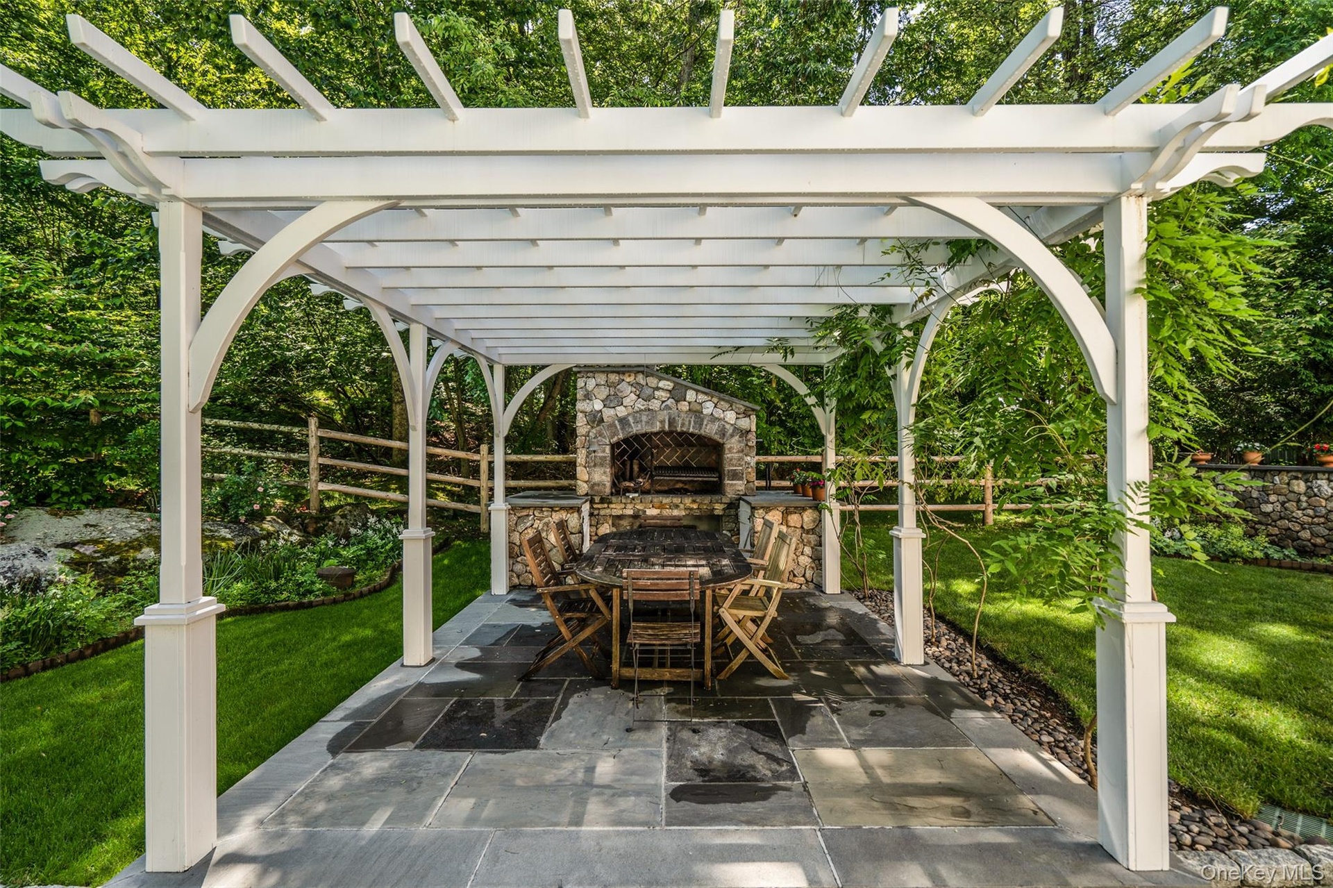 An outdoor fireplace overlooking your pool.  Doesn't get any better than this!