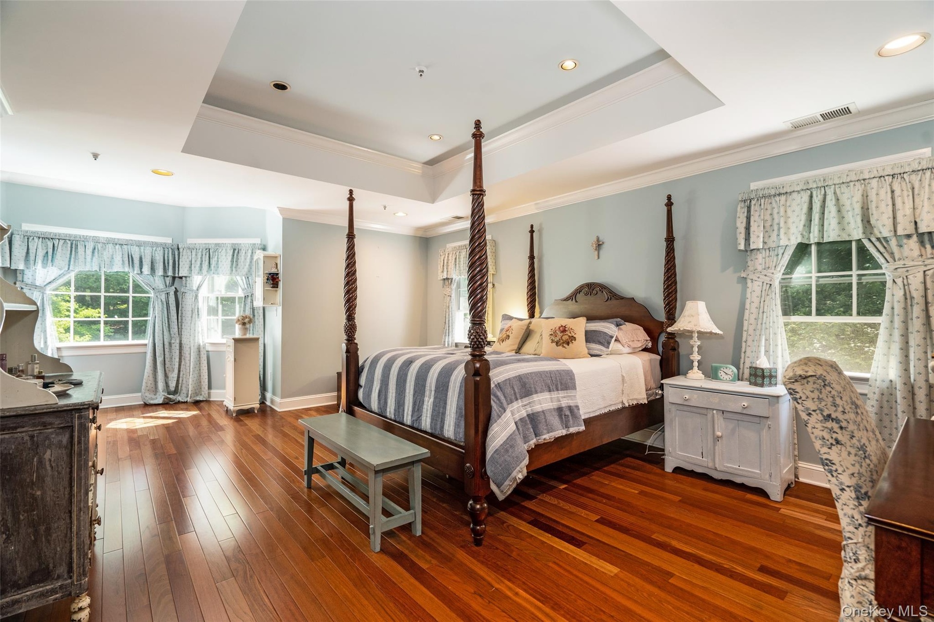 This primary suite is your own personal retreat. With elegant tray ceilings and a dedicated sitting area, it's the perfect place to reset after a long