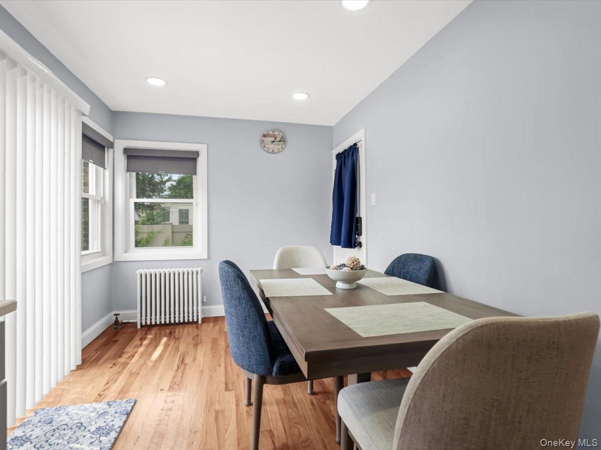 Wood-finish flooring with light blue walls and recessed ceiling lighting