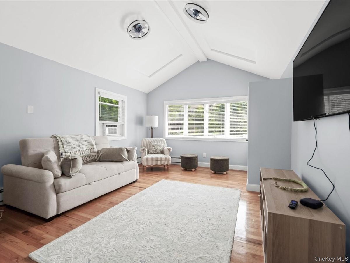 Bright and inviting with vaulted ceilings, exposed beams, hardwood floors, and plenty of natural light.