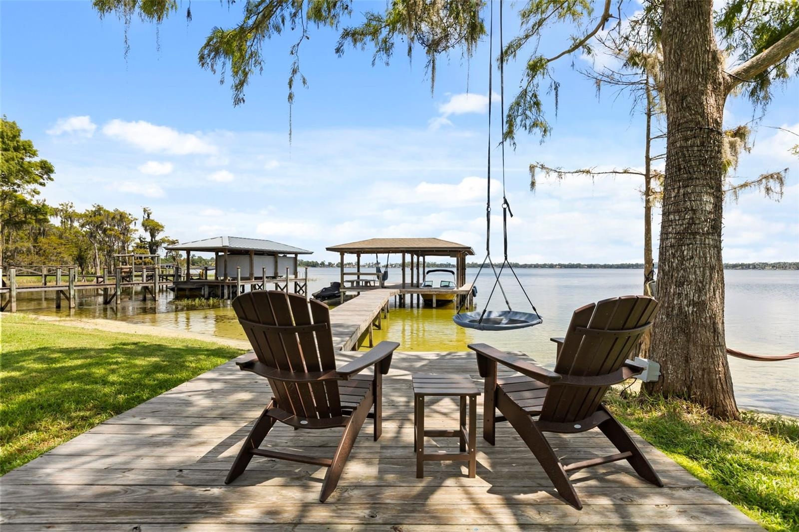 A private dock and boatlift provide immediate access to Lake Sheen and the entire Butler Chain, while a gated community boat ramp is approximately 300