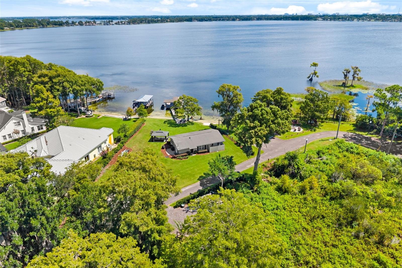 An exceptional opportunity to own one of the most compelling lakefront properties on Lake Cottage Lane, featuring an oversized homesite, expansive Lak