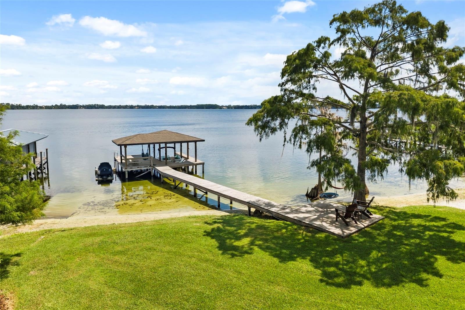 A private dock and boatlift provide immediate access to Lake Sheen and the entire Butler Chain, while a gated community boat ramp is approximately 300