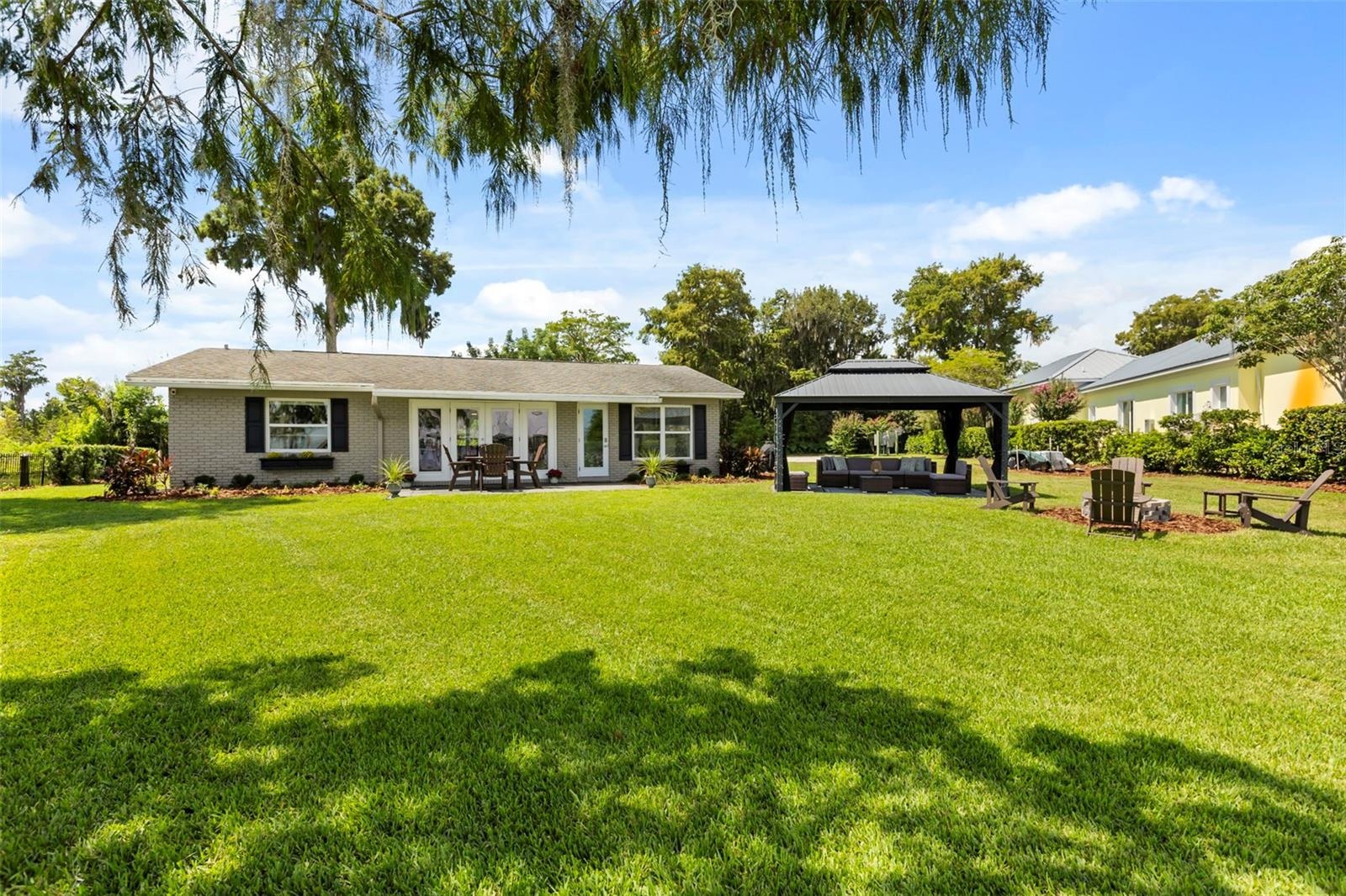 Lake Cottage Lane, featuring an oversized homesite, expansive Lake Sheen views, sandy shoreline, private dock and boatlift, and an existing 2BR/1.5BA 