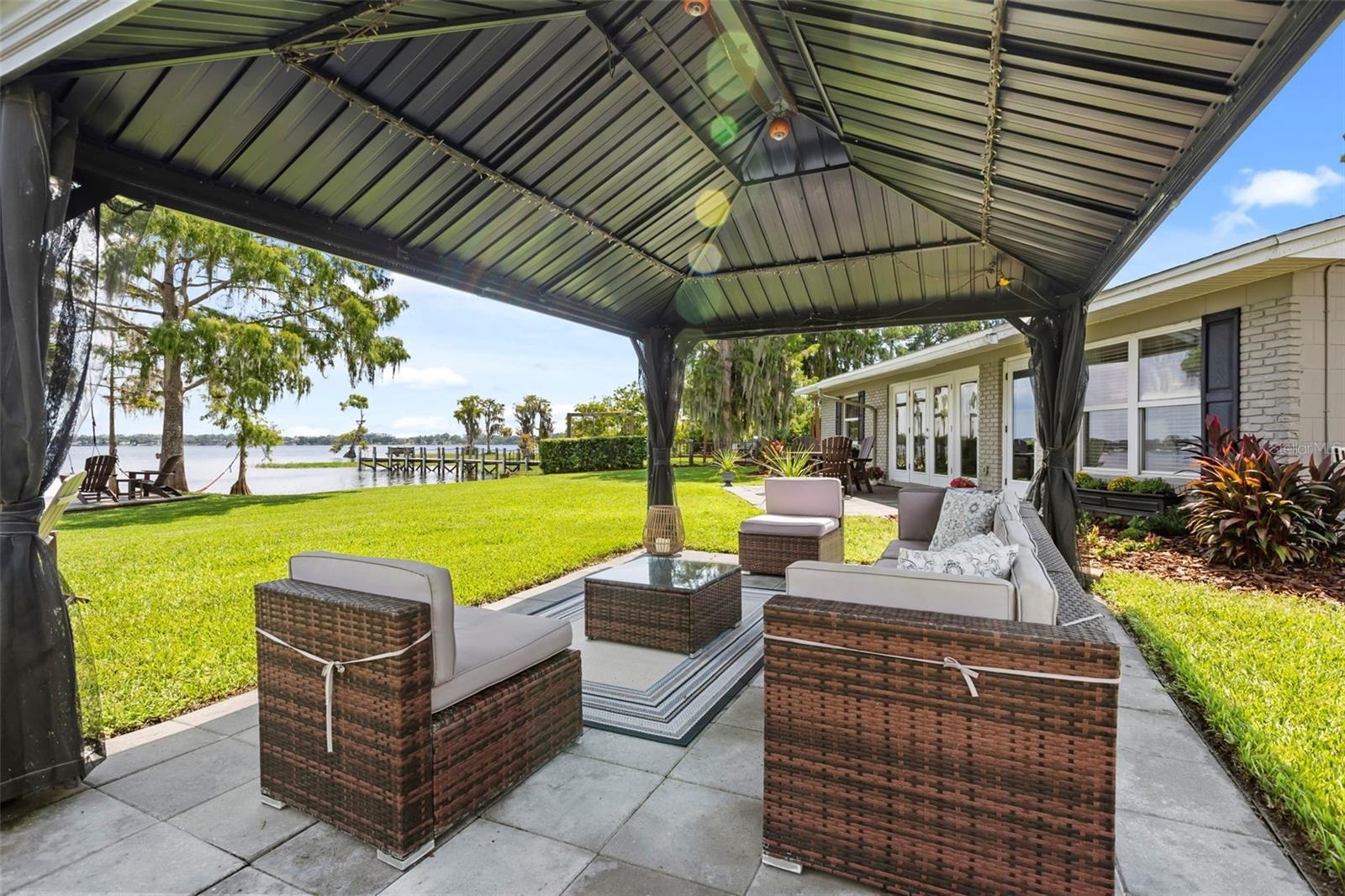Lake Cottage Lane, featuring an oversized homesite, expansive Lake Sheen views, sandy shoreline, private dock and boatlift, and an existing 2BR/1.5BA 