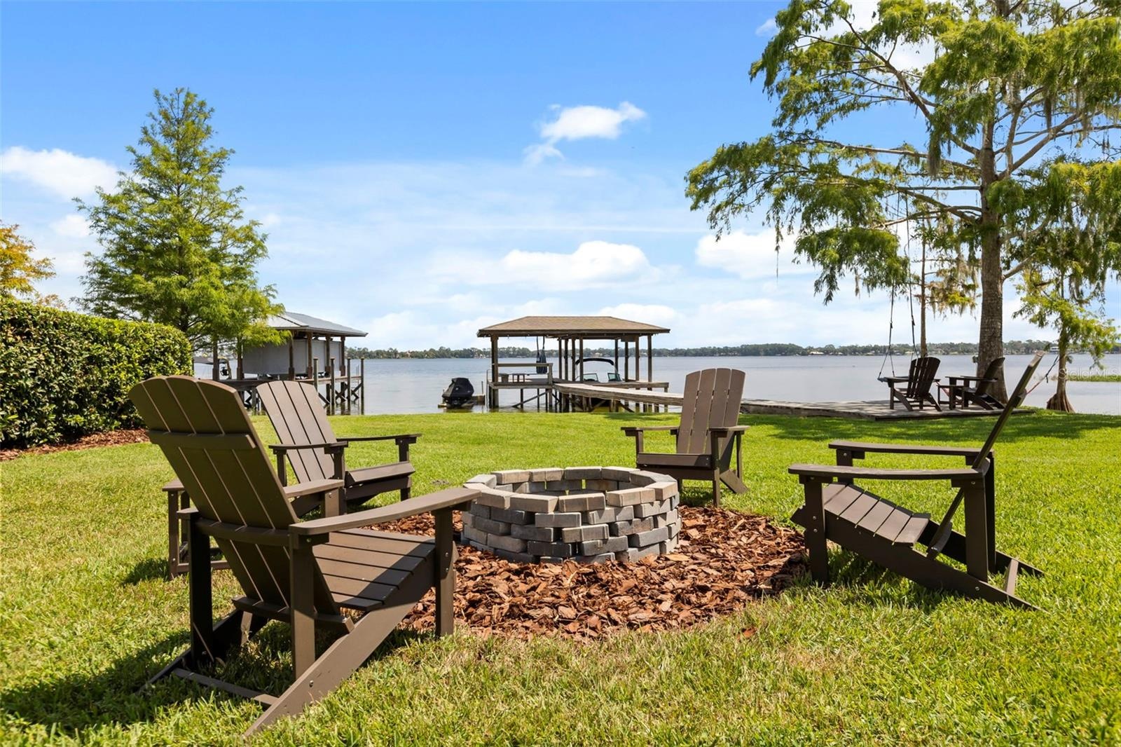 Lake Cottage Lane, featuring an oversized homesite, expansive Lake Sheen views, sandy shoreline, private dock and boatlift, and an existing 2BR/1.5BA 