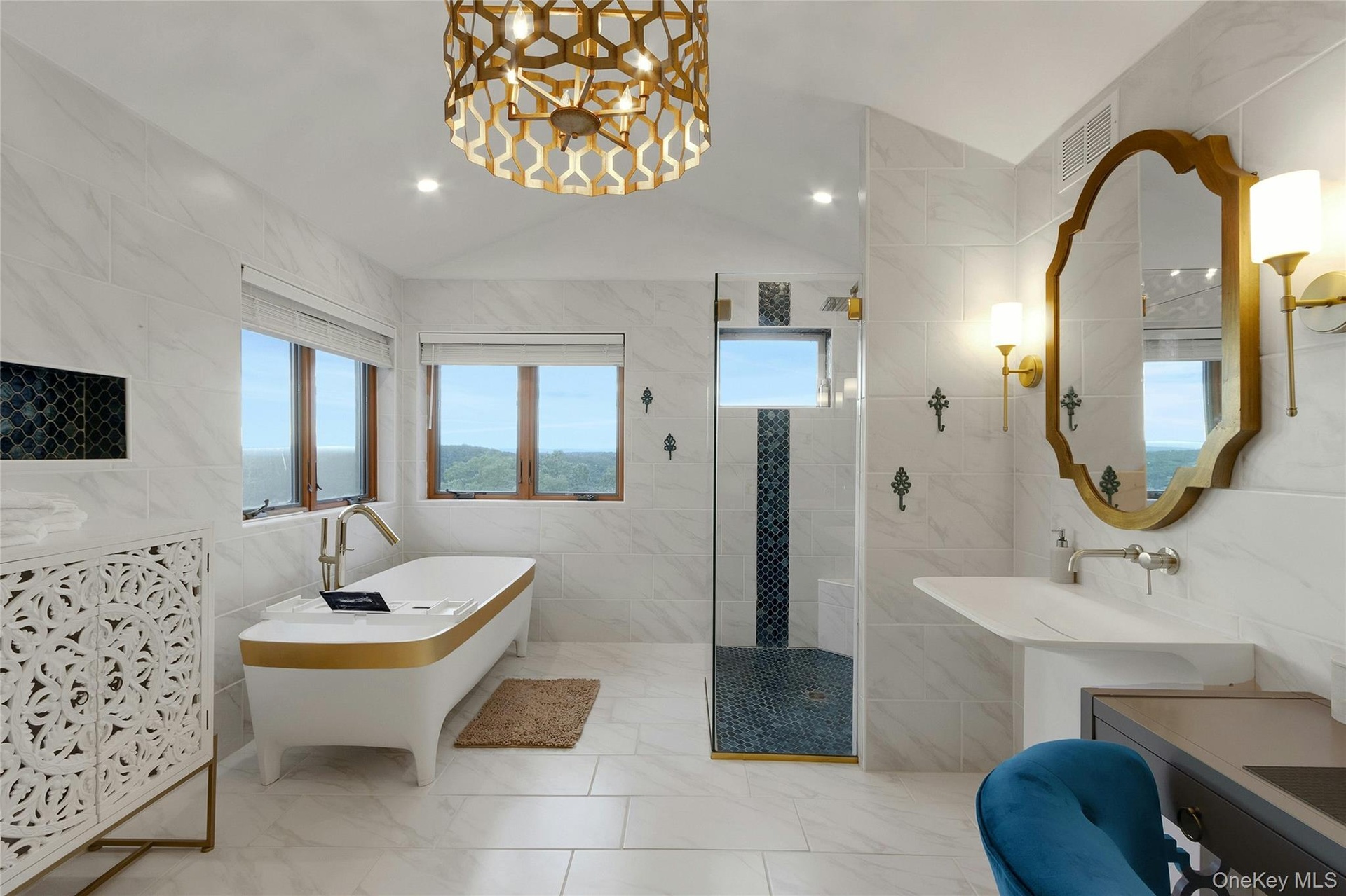 Freestanding soaking tub, walk-in shower with glass enclosure, single vanity with wall-mounted faucet, and a decorative overhead light fixture
