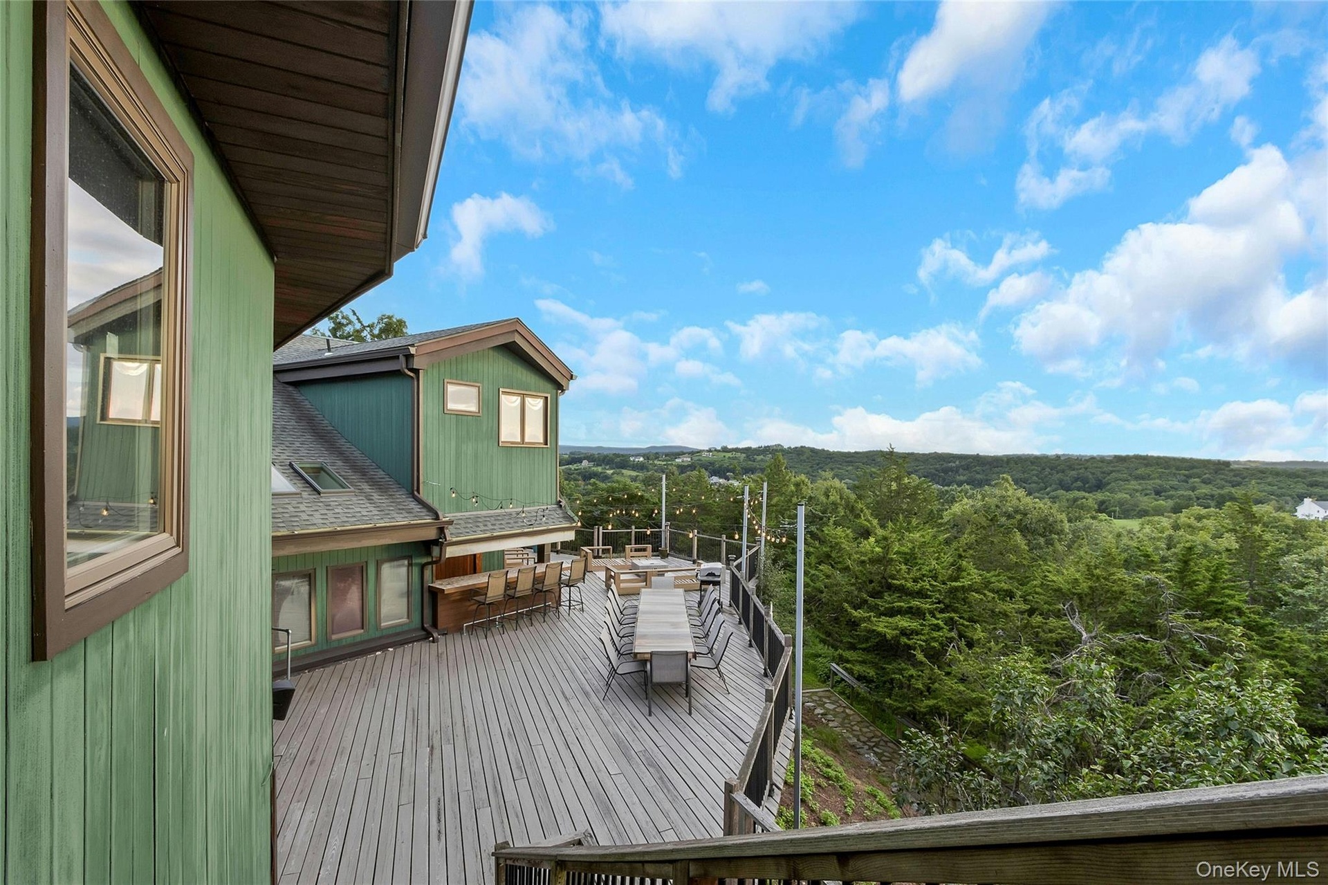 Expansive multi-level wood deck, outdoor entertainment area, and skylights